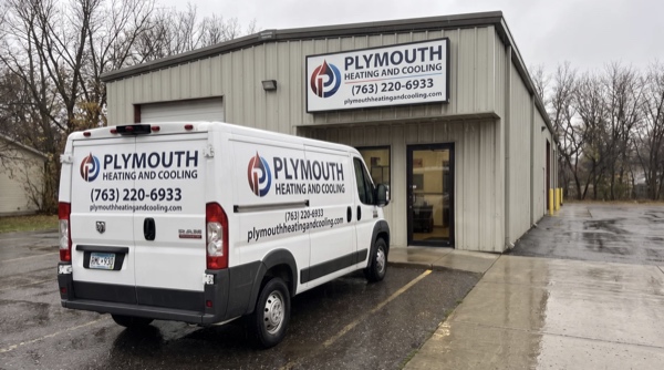 Plymouth Heating And Cooling facility with garage and signage