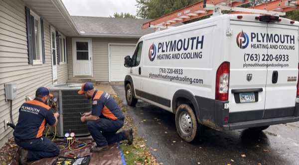 Plymouth Heating And Cooling technician performing HVAC maintenance